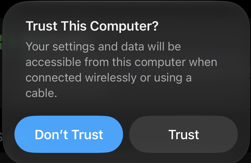 The “Trust This Computer?” alert on an iPhone, with the Trust button highlighted.